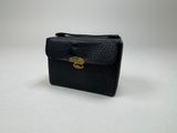 a black purse with a gold clasp on it
