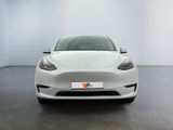 a white tesla model s parked in a white room