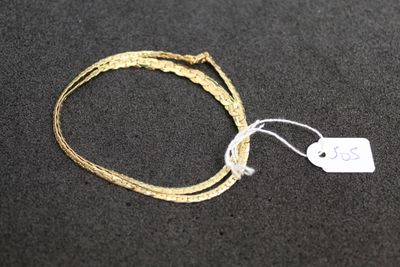 a close up of a string bracelet with a tag attached to it