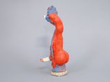 a small figurine of a red and blue bird