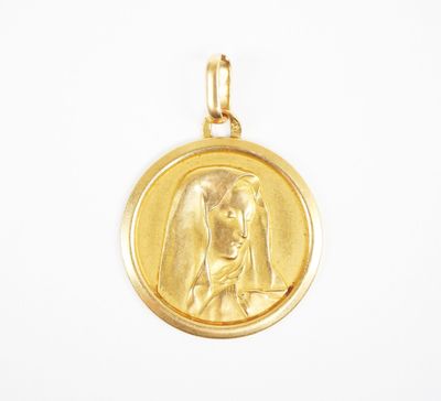 an image of a gold medal with a woman ' s face on it