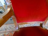a red chair that is sitting on a rug