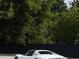 an image of a white sports car parked in a parking lot