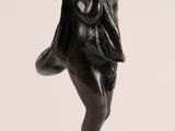 pair of bronze figurines of a boy with a bird on his shoulder