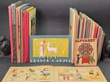 several children ' s books are lined up in a row on a table
