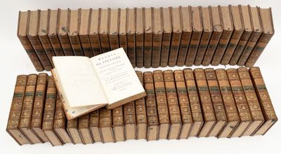an open book sitting on top of a pile of old books