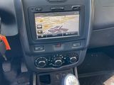 a car dashboard with a steering control and a dash button