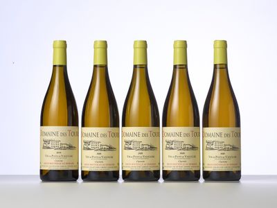 four bottles of wine are lined up on a table