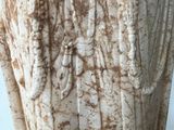 marble statue of an angel holding a cross on a pedestal
