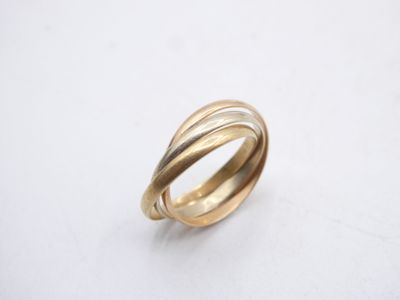 a close up of a gold ring on a white surface