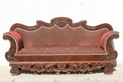 a wooden bench that is sitting on the sidewalk