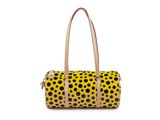a yellow and black polka dot bag with a tan handle