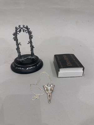a book, a necklace, and a book sitting on a table