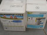 two boxes of inflatable swimming equipment sitting on the ground
