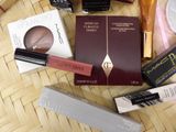 many different makeup products laid out on a table