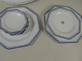 three plates and a bowl sitting on a table
