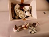 a box with a bunch of china items in it