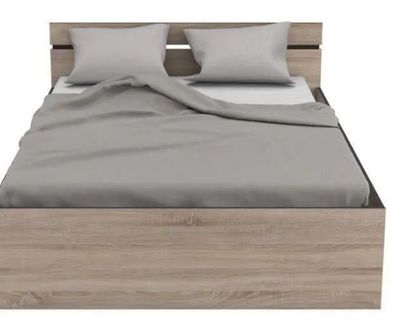the bed frame is made of wood and has two pillows on it
