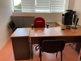 a desk with a chair and a computer on it