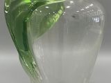 a glass vase with a green leaf inside of it