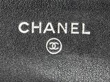 a close up of a black chanel purse with the word chanel written on it