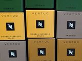 many boxes of different flavored coffees stacked on top of each other