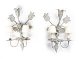 pair of metal wall sconces with flowers and leaves on each of them