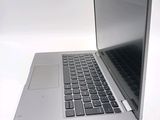a silver laptop computer sitting on top of a white table