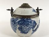 an image of a blue and white vase with a lid on a white surface
