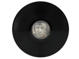 an old vinyl record with a picture of a man ' s face on it