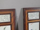 two picture frames with asian writing on them on the wall