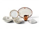 many different types of plates and bowls on the table