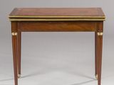 an antique mahogany writing table with brass trimming