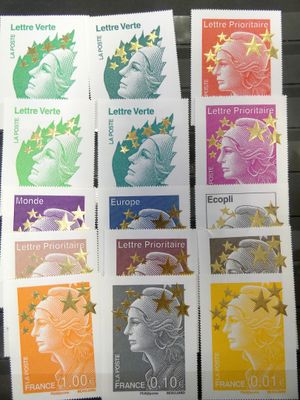 four different stamps of different colors and designs on a table