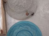 three plates and a bowl on the floor next to each other