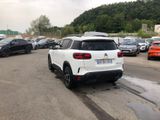 a white suv parked in a parking lot next to other cars