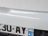 a close up of a license plate on a white car