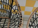 two wicker chairs that are sitting on a tiled floor