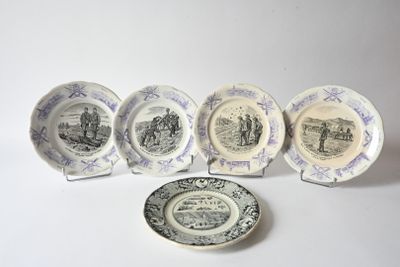 several plates and a plate with a picture of people on them