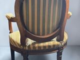 an image of a wooden chair with a striped upholstered seat