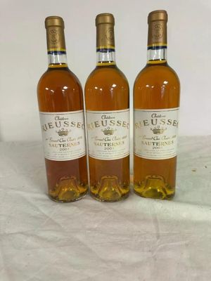 three bottles of wine sitting on top of a table next to each other