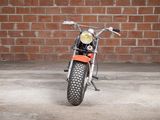 a motorcycle that is parked in front of a brick wall