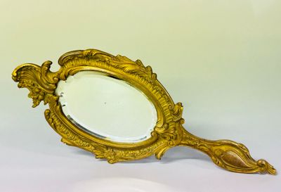 a mirror that is sitting on a white surface