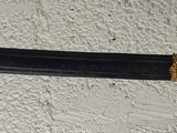 a sword that is on display on the wall