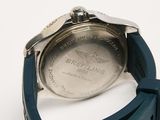 a close up of a watch on a white surface