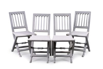 four chairs sitting next to each other on a white surface