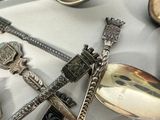 a lot of silver spoons and spoons on a table