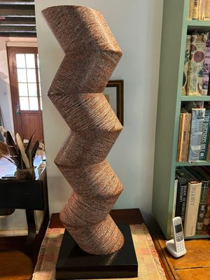 a tall sculpture made out of jute rope on a table