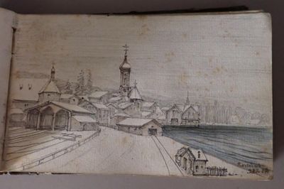 an old book with a drawing of a town in the middle of it