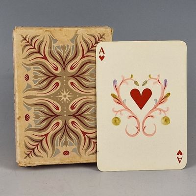 a playing card sitting next to a box with a heart on it